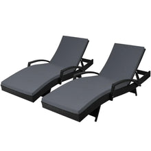Pair of outdoor black wicker lounge chairs with grey cushions and adjustable backs