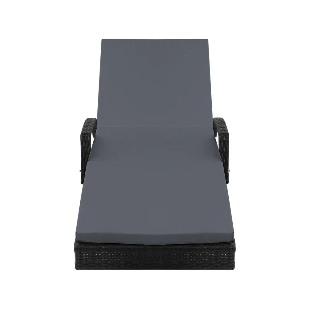 Outdoor lounge chair with dark rattan frame and grey cushion, viewed from the front