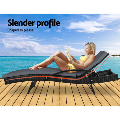 Outdoor rattan lounge chair with cushion on deck by beach, woman relaxing in swimwear