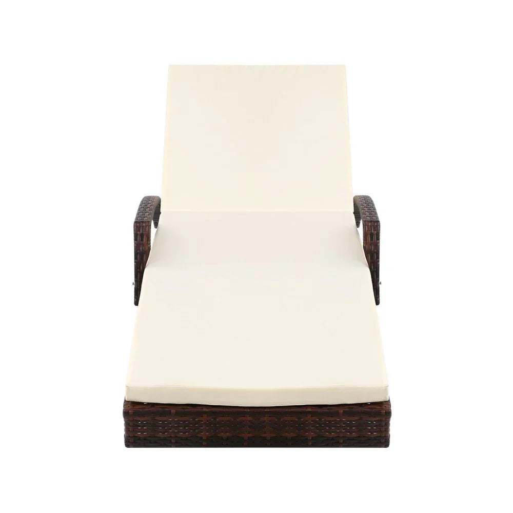 Outdoor wicker lounge chair with cream cushion and armrests, front view