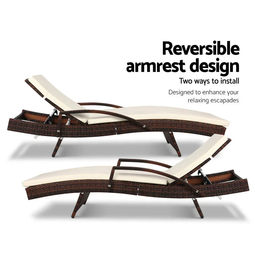Outdoor lounge chair with reversible armrest and adjustable reclining positions, wicker frame, cream cushion.