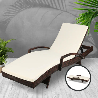 Outdoor wicker lounge chair with cream cushion, adjustable backrest, plants nearby