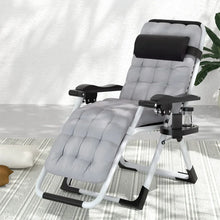 Padded grey reclining lounge chair with headrest, cup holder, and armrests on a patterned rug