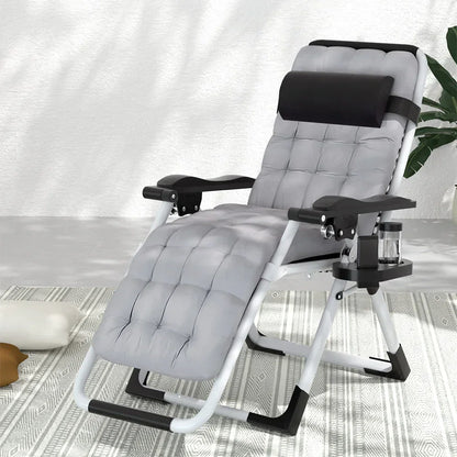 Padded grey reclining lounge chair with headrest, cup holder, and armrests on a patterned rug