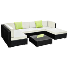 7-piece outdoor wicker sofa set with cream cushions, lime green pillows, and glass coffee table