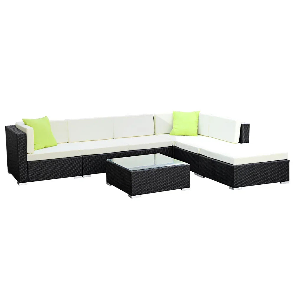 Black rattan outdoor sectional sofa set with cream cushions, lime green pillows, and glass-top coffee table