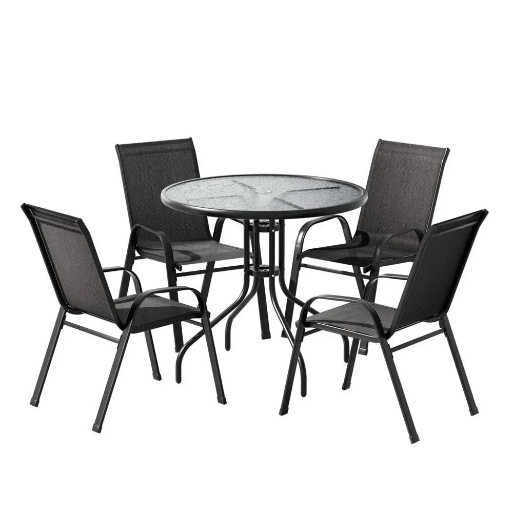 Outdoor dining set with round glass table and four black metal chairs