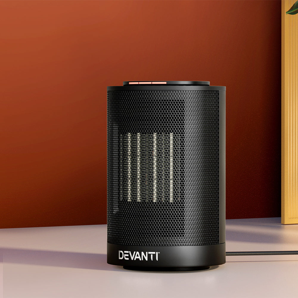 Black Devanti electric ceramic tower heater on table against red wall