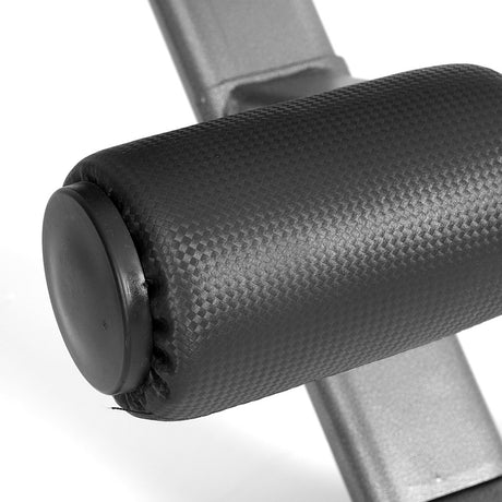 Close-up of textured black foam roller pad on adjustable fitness bench frame