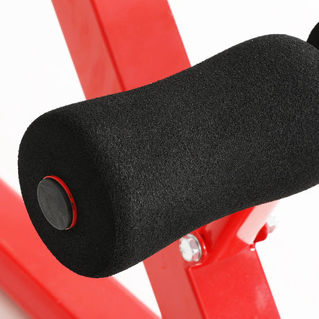Close-up of black foam roller leg support on red adjustable weight bench