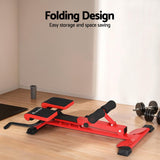 Red folding workout bench with black padding, dumbbells nearby, space-saving home gym equipment