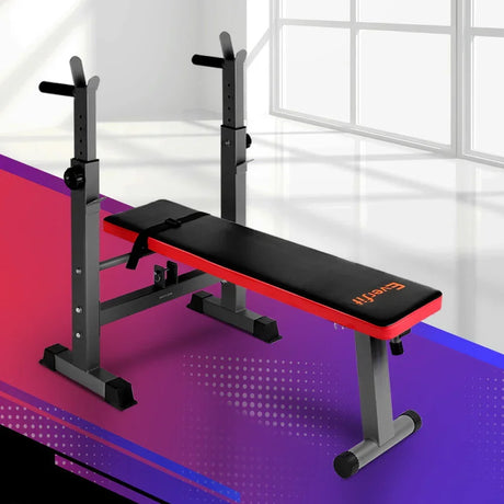 Adjustable weight bench with black padding and red trim in a modern home gym setting