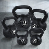 Set of black kettlebells in 2kg, 4kg, 6kg, and 8kg on a gym floor
