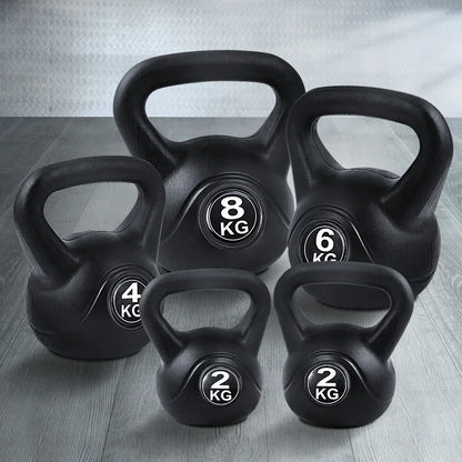 Set of black kettlebells in 2kg, 4kg, 6kg, and 8kg on a gym floor