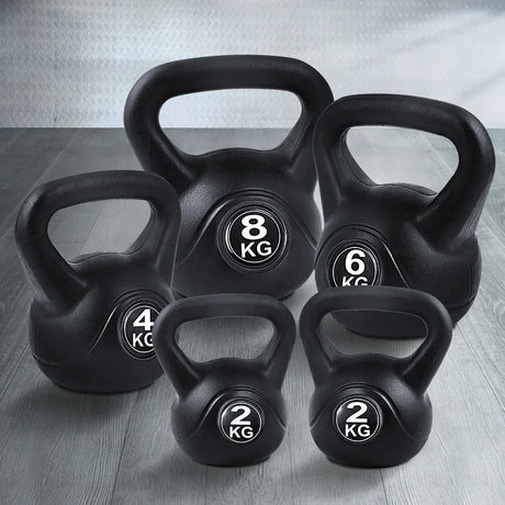 Set of black kettlebells in 2kg, 4kg, 6kg, and 8kg on a gym floor