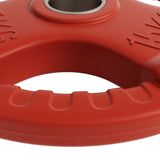 Close-up of a red 15kg weight plate with grip handles and central metal ring