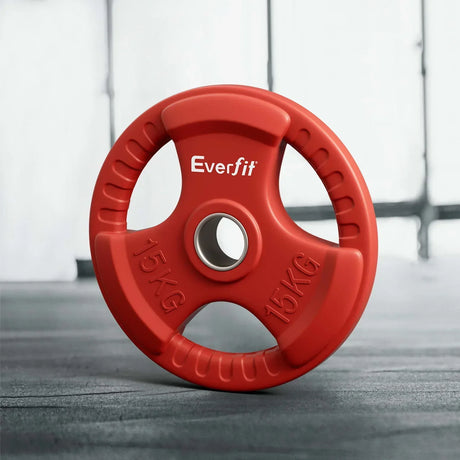 Red 15KG Everfit weight plate with grip handles on gym floor