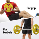 Man using yellow 20kg weight plate for exercise, suitable for barbells or grip workouts