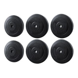 Set of six black weight plates with 5kg and 10kg markings for gym or home fitness