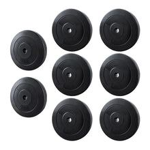 Set of eight black weight plates, 5kg and 10kg, for home gym or barbell training