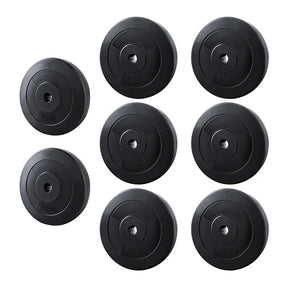 Set of eight black weight plates, 5kg and 10kg, for home gym or barbell training