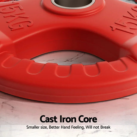 Close-up of red 15kg cast iron weight plate with grip handles on marble surface.