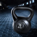 Black 16kg kettlebell on a textured gym floor, fitness equipment close-up