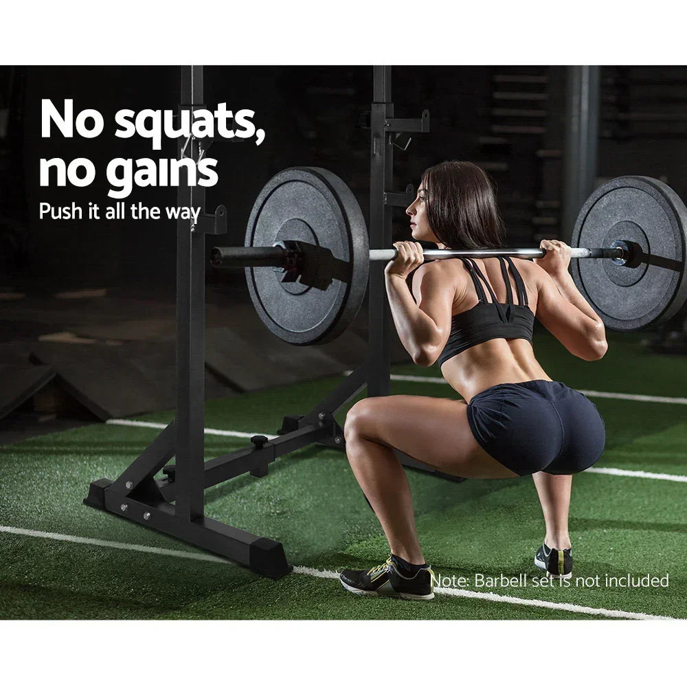 Woman performing squat with weights on a black squat rack in a gym setting