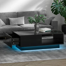Modern black coffee table with drawer and blue LED lights in a living room setting