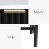 Close-up of black cabinet with gold sleek handle, white top, and sturdy metal legs