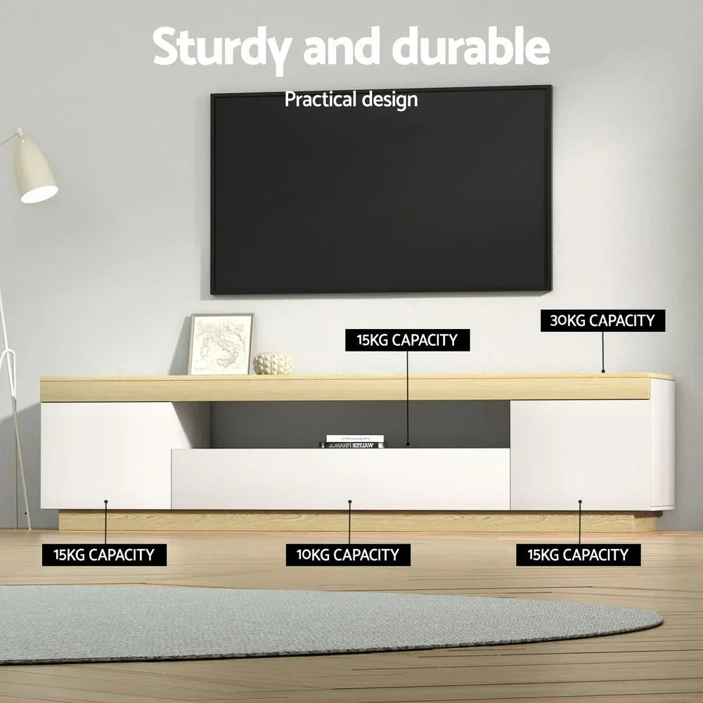Modern white and wood TV cabinet with storage, labelled weight capacities, under wall-mounted TV.