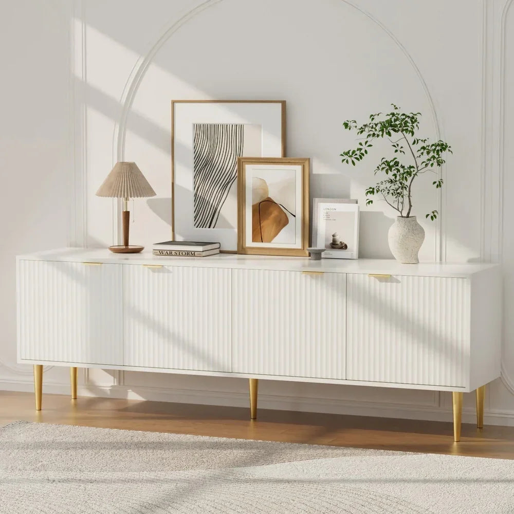 Modern white sideboard with gold legs, abstract art, lamp, and decorative vase in a bright room