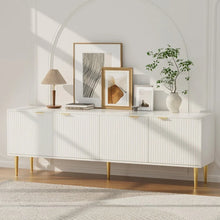 Modern white sideboard with gold legs, abstract art, lamp, and decorative vase in a bright room