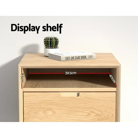 Wooden display shelf with open compartment, dimensions labeled, cactus and book on top.