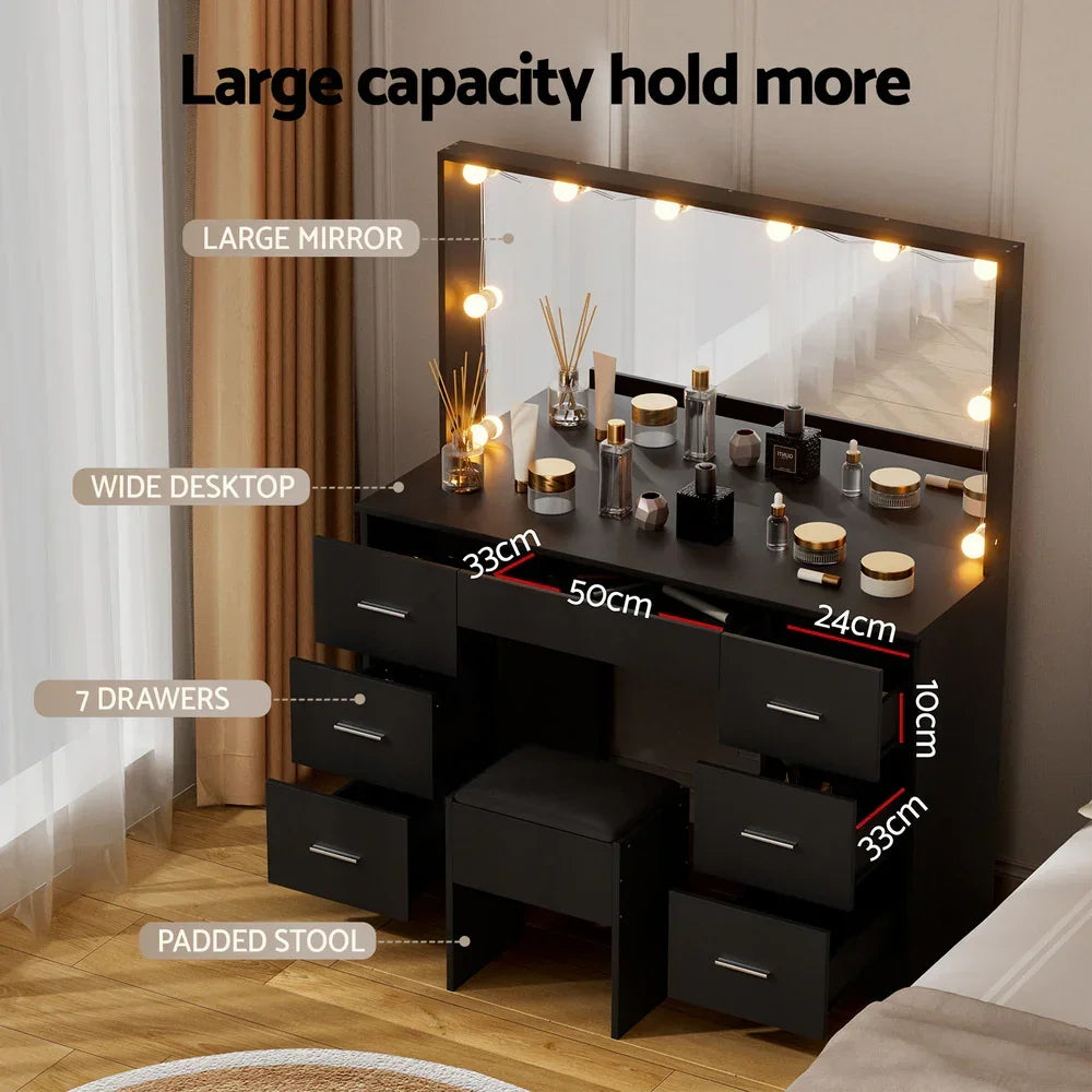 Black makeup vanity with large mirror, LED lights, 7 drawers, wide desktop, and padded stool.
