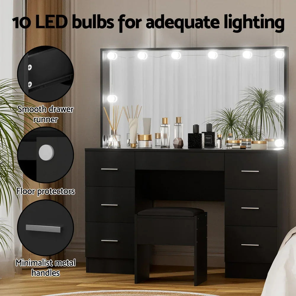 Black vanity table with mirror, 10 LED bulbs, drawers, stool, and decorative items.