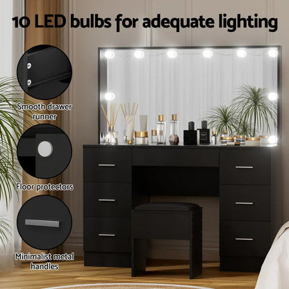 Black vanity table with mirror, 10 LED bulbs, drawers, stool, and decorative items.
