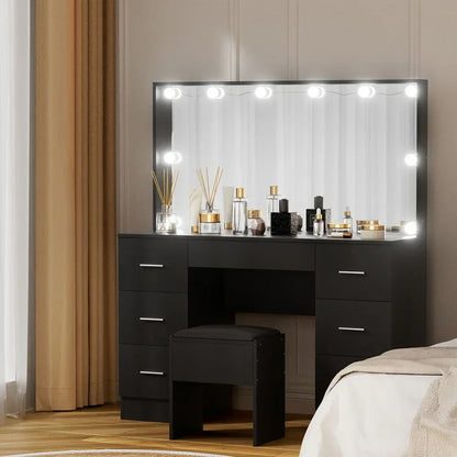Black vanity table with LED mirror, storage drawers, stool, and assorted cosmetic bottles
