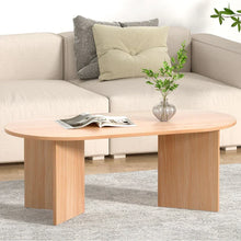 Modern wooden coffee table with oval top, magazine, and glass vase in a living room setting