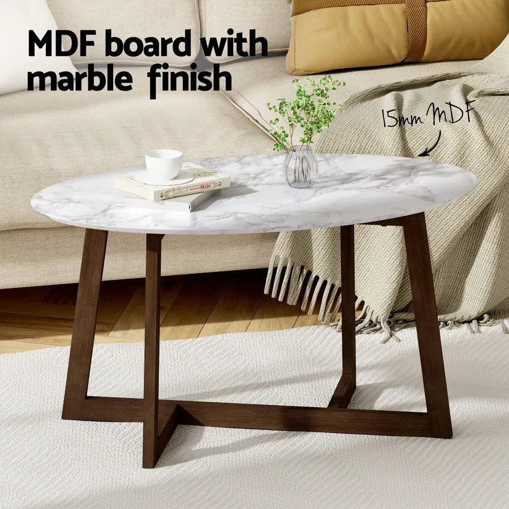 Oval coffee table with marble finish MDF top and wooden legs in modern living room.