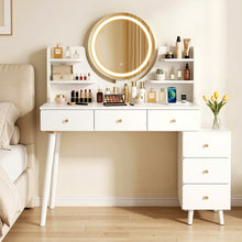 White vanity table with LED mirror, shelves, and drawers, styled with makeup and perfumes in a cozy bedroom.