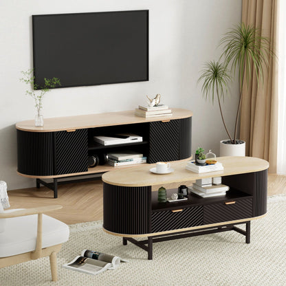 Modern black and wood TV stand & coffee table set with storage, styled in cozy living room with plant and TV