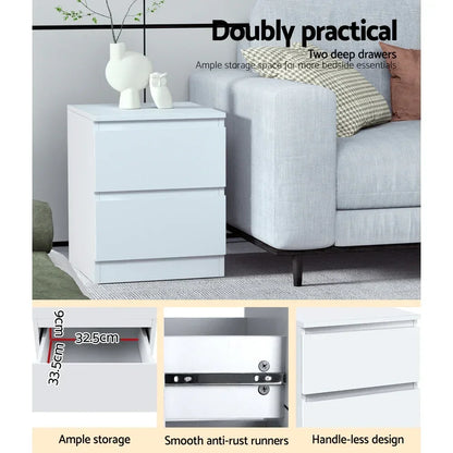 White bedside table with two deep drawers, modern handleless design beside a grey sofa.