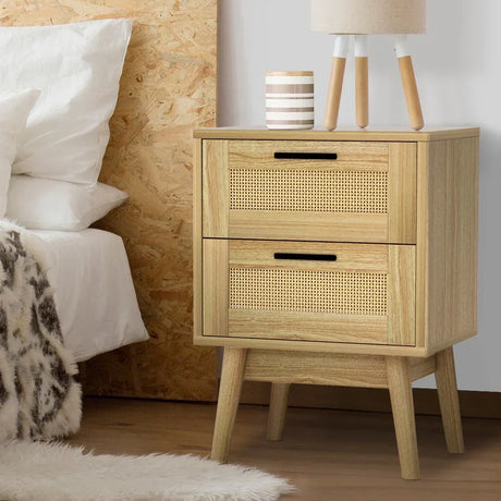 Wooden bedside table with rattan drawers, modern decor in bedroom setting