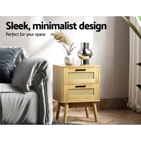 Modern wooden bedside table with two rattan drawers in a cozy living room setting