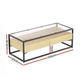 Rectangular glass top coffee table with black metal frame and light wood drawers, dimensions labeled.