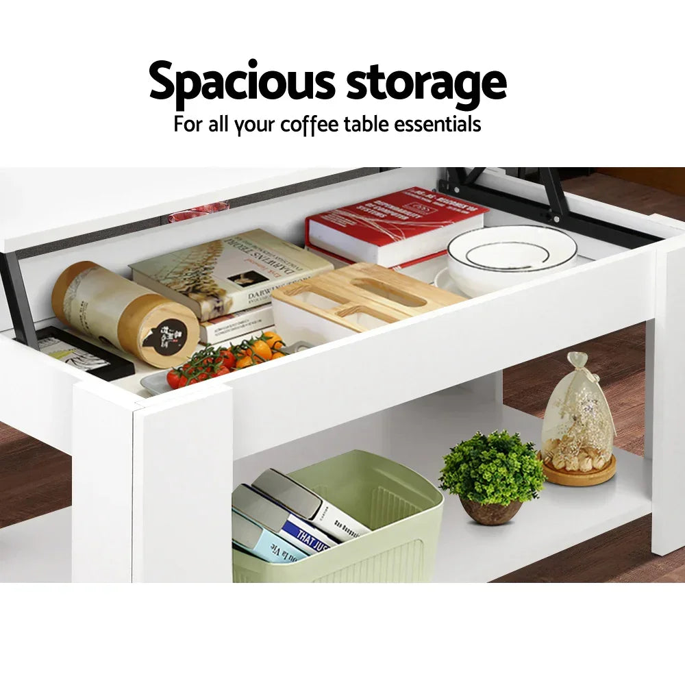 White lift-top coffee table with spacious storage compartments, books, dishes, and decor.