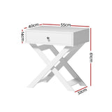 White bedside table with single drawer, cross-legged base, and labeled dimensions.