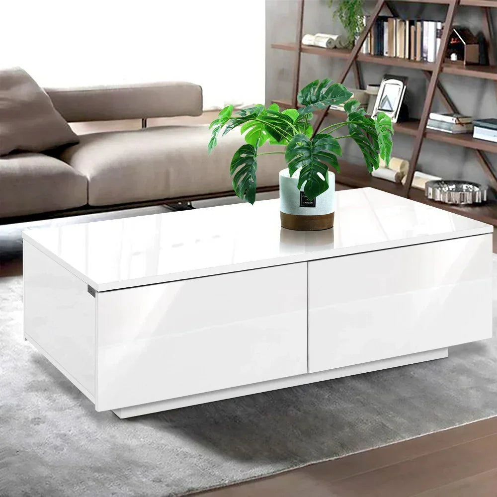 Modern white coffee table with glossy finish and potted plant in a stylish living room