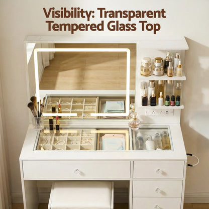 White makeup vanity with LED mirror, transparent tempered glass top, and organized cosmetics.
